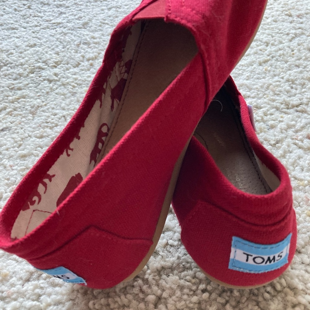 Red Tom’s shoes, never worn